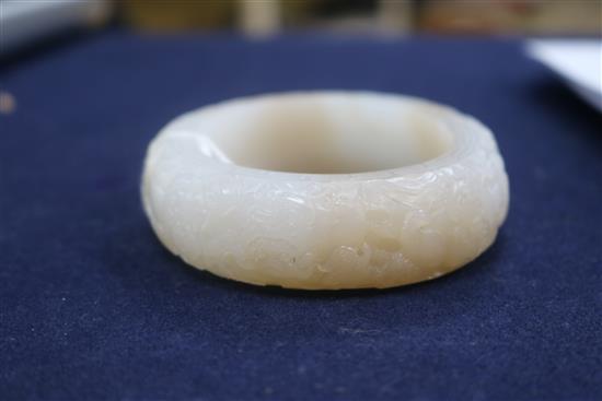 A Chinese white and russet jade bangle